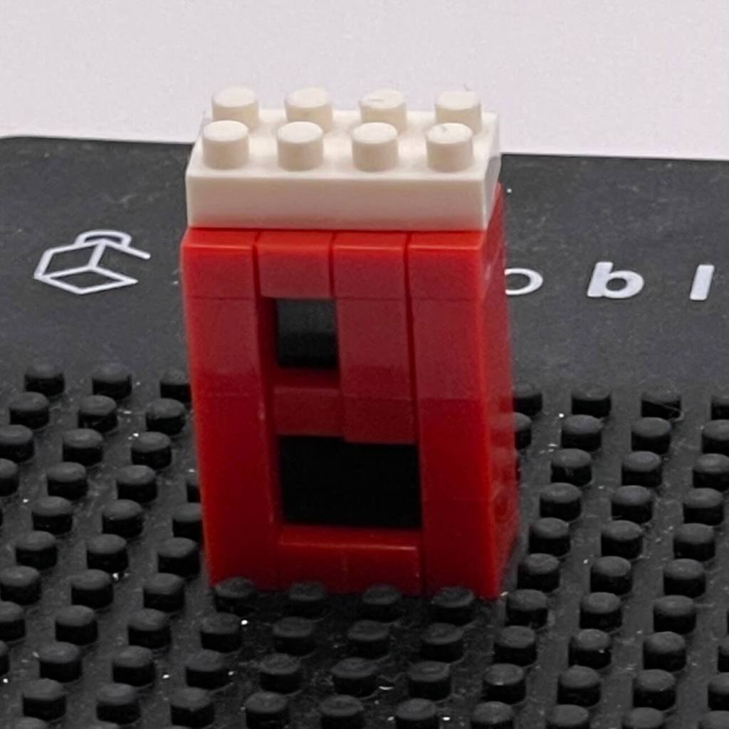 The coin slot from the ZRK Mini Toy Machine re-built separately on a Nanoblock pad.