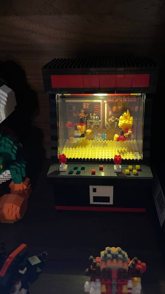 Fighting Game Arcade Cabinet Micro Block set, displayed in a shelf with the light feature on display.